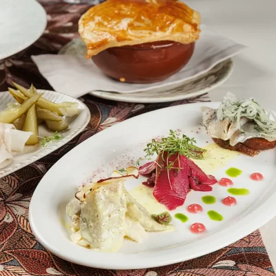 Тушенка из баранины с картофелем и овощами от Ресторана «Кухмистр» (в горшочке на заднем плане)